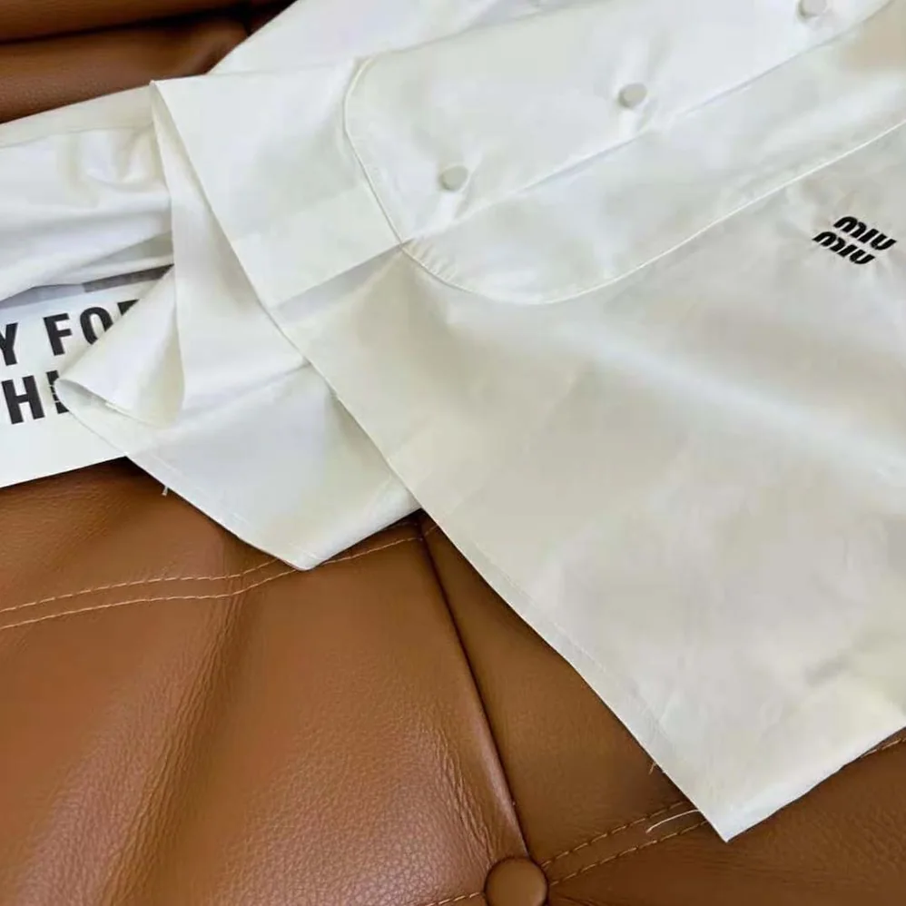 Miu Miu Poplin Shirt with Yarn-Embroidered Logo for Women in White Miu Miu Poplin Shirt with Yarn-Embroidered Logo for Women in White