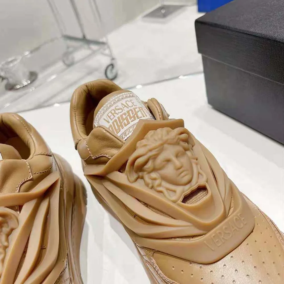 Versace Odissea Sneakers are Set on Rubber Soles with Perforated Toe Caps for Unisex in Brown Versace Odissea Sneakers are Set on Rubber Soles with Perforated Toe Caps for Unisex in Brown