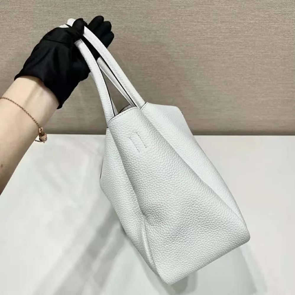 Prada Large Leather Handbag with the Prada Metal Lettering Logo Gleaming at Its Center for Women in White Prada Large Leather Handbag with the Prada Metal Lettering Logo Gleaming at Its Center for Women in White