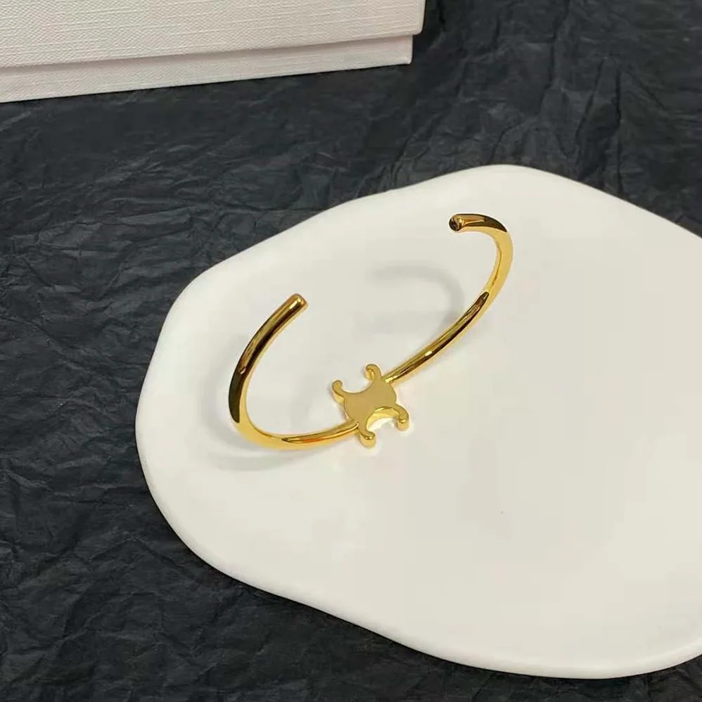 Celine Triomphe Asymmetric Cuff in Brass with Gold Finish for Women Celine Triomphe Asymmetric Cuff in Brass with Gold Finish for Women