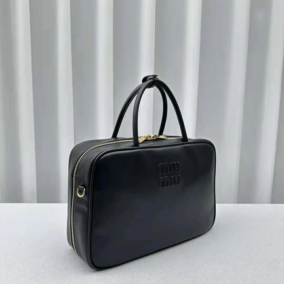 Miu Miu Leather Top-handle Bag with Embossed Lettering Logo for Women in Black Miu Miu Leather Top-handle Bag with Embossed Lettering Logo for Women in Black