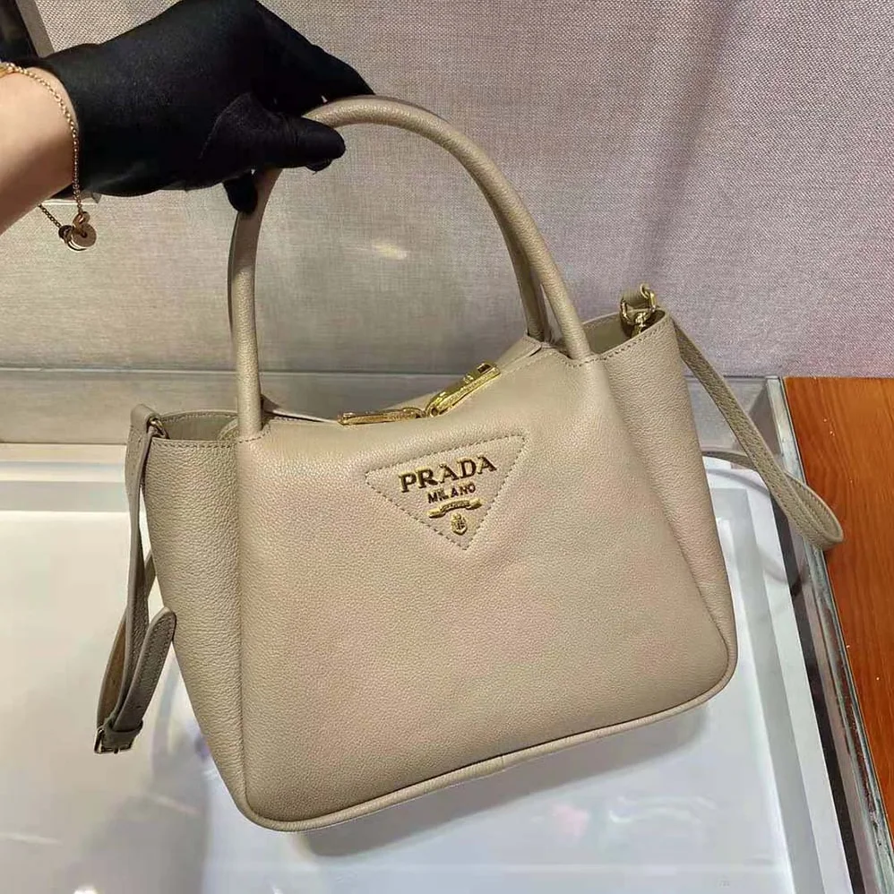Prada Small leather Handbag with the Prada Metal Lettering Logo Illuminating Its Center for Women in Sandy