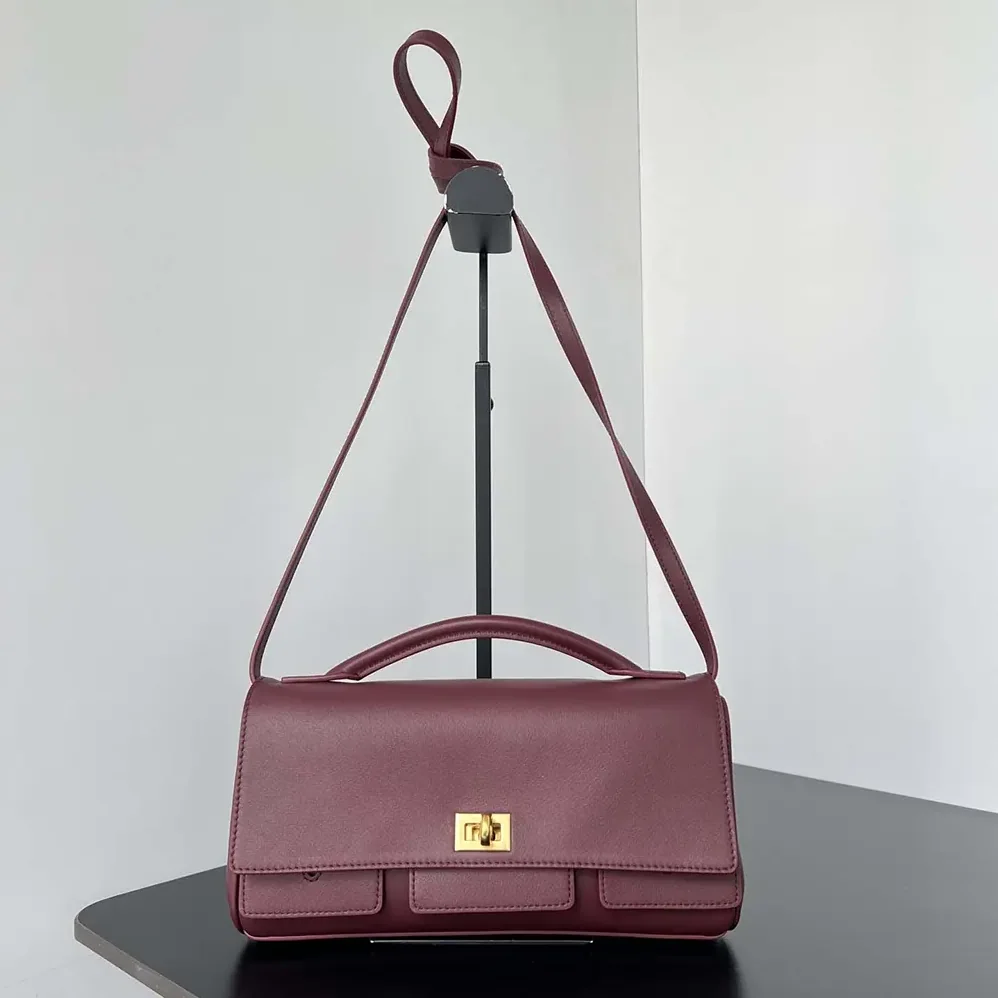 Balenciaga Bel Air Clutch On Strap Small in Dark Burgundy for Women Balenciaga Bel Air Clutch On Strap Small in Dark Burgundy for Women