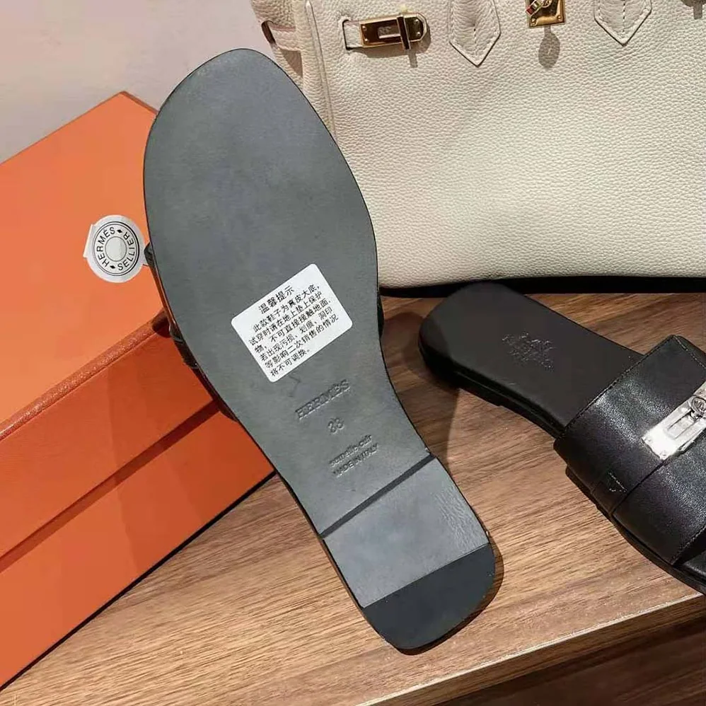 Hermes Giulia Sandal in Calfskin with Iconic Palladium-Plated Kelly Buckle for Women in Black Hermes Giulia Sandal in Calfskin with Iconic Palladium-Plated Kelly Buckle for Women in Black