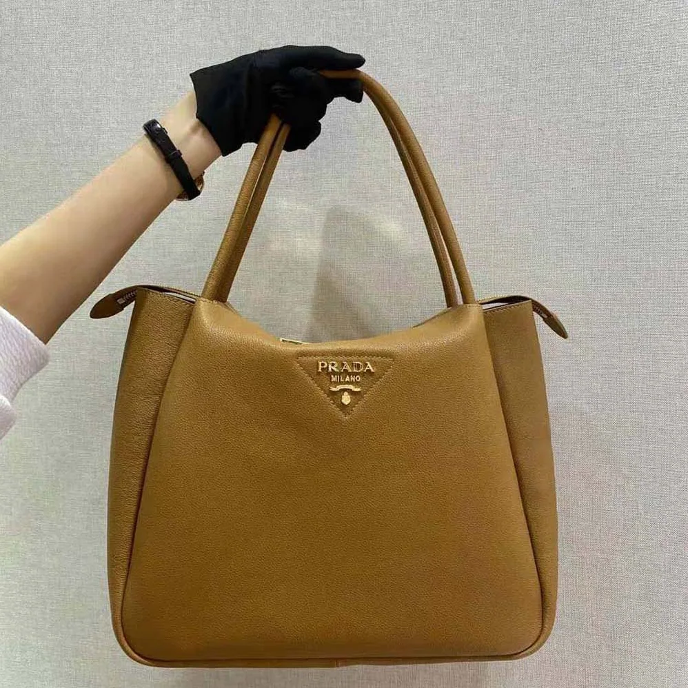 Prada Medium Leather handbag with the Prada Metal Lettering Logo Illuminating Its Center for Women