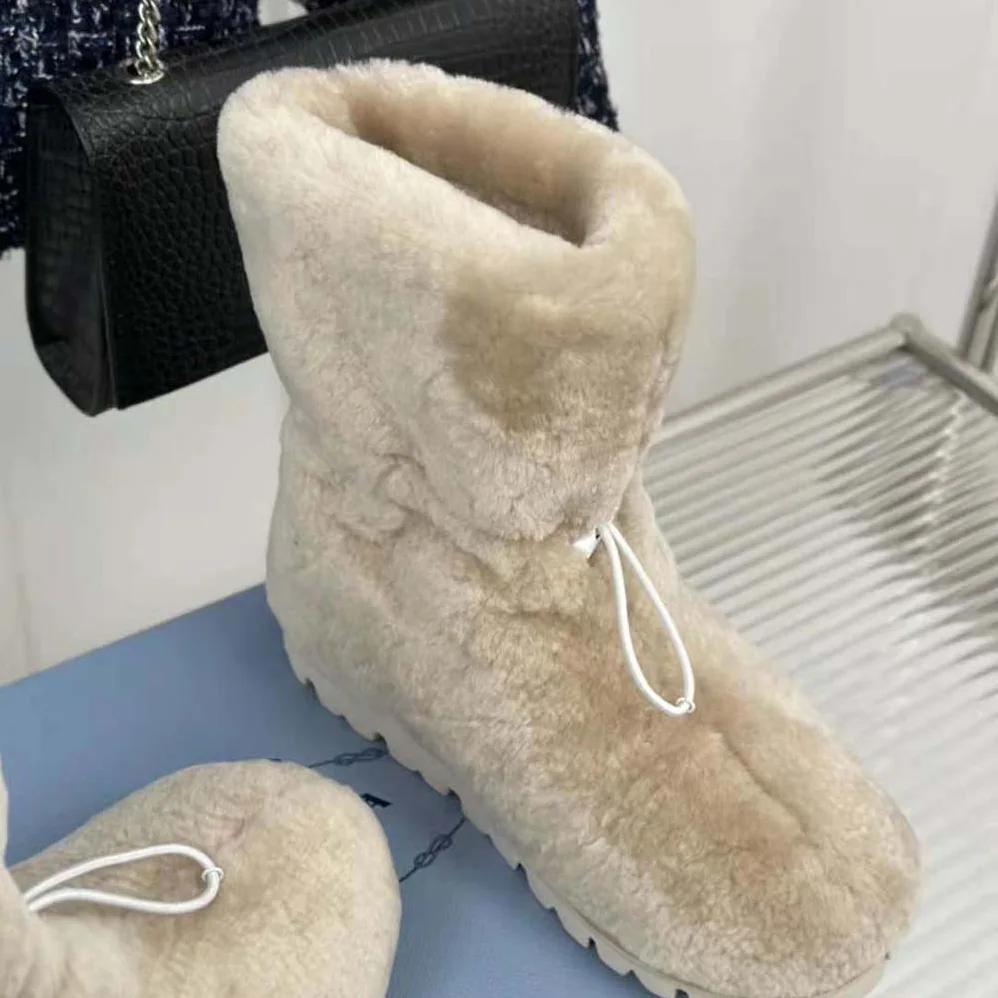 Prada Shearling Booties with Enameled Metal Triangle Logo for Women in Beige