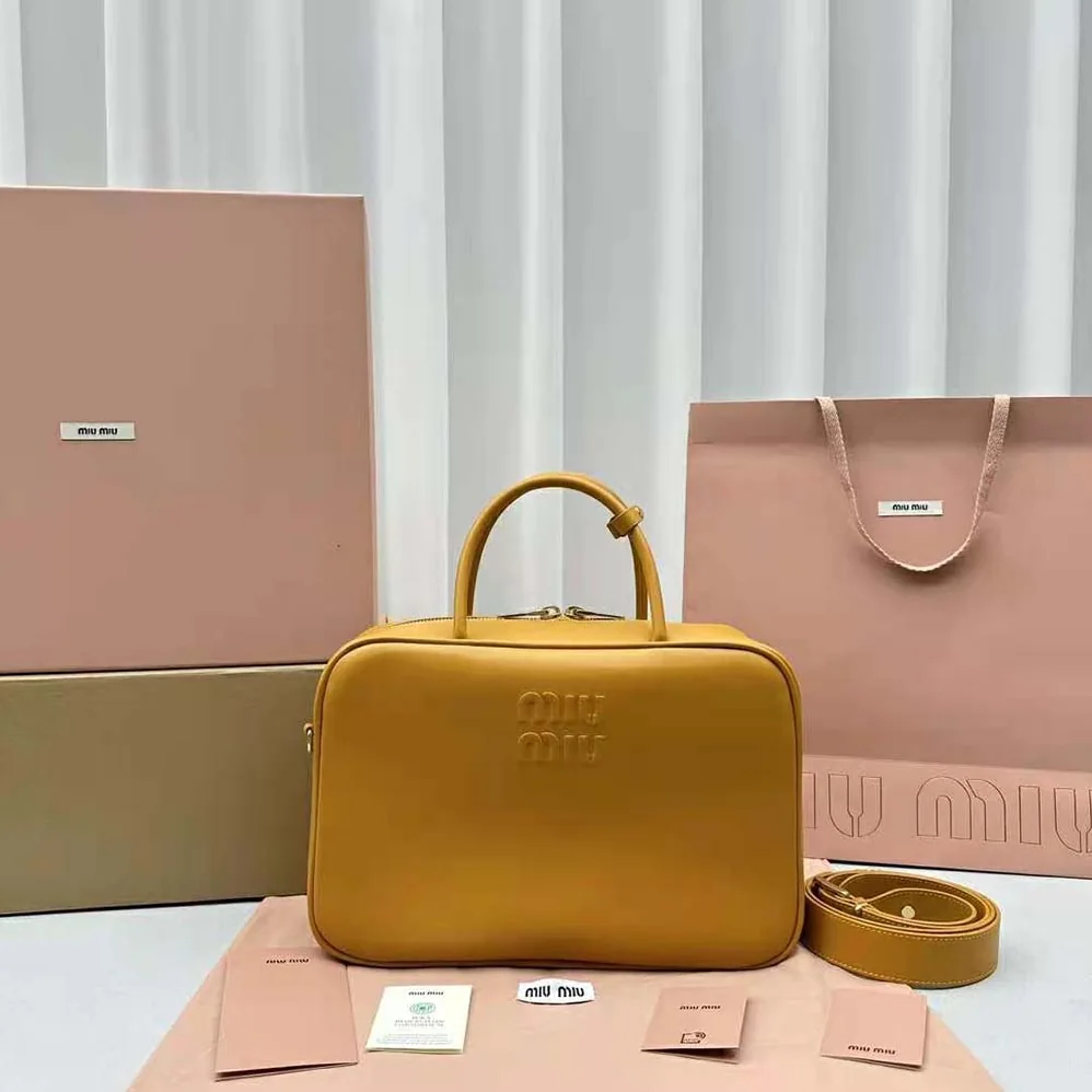 Miu Miu Leather Top-handle Bag with Embossed Lettering Logo for Women in Orange Miu Miu Leather Top-handle Bag with Embossed Lettering Logo for Women in Orange