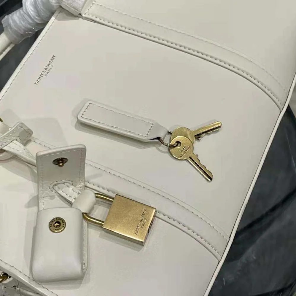 Saint Laurent YSL Lock Baby Duffle in Smooth Leather for Women in White Saint Laurent YSL Lock Baby Duffle in Smooth Leather for Women in White