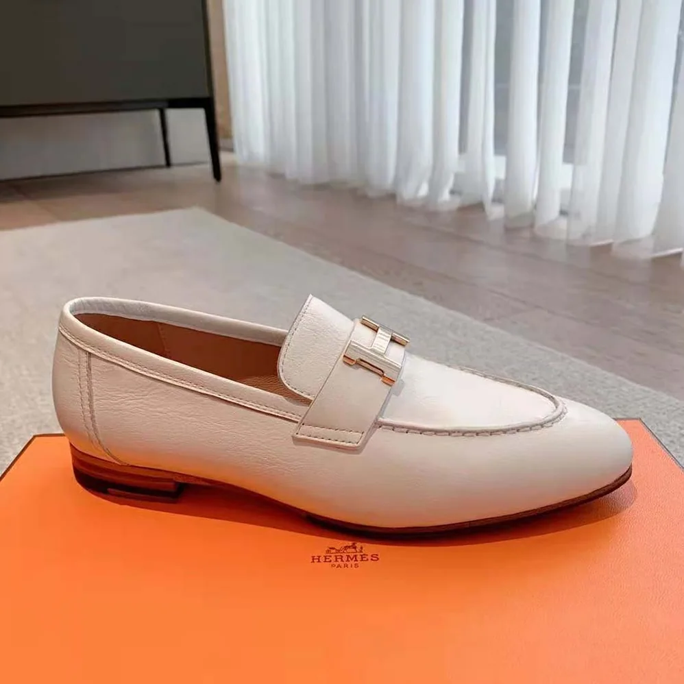 Hermes Paris Loafer in Calfskin with Palladium Plated Signature “H” Detail for Women in White Hermes Paris Loafer in Calfskin with Palladium Plated Signature “H” Detail for Women in White