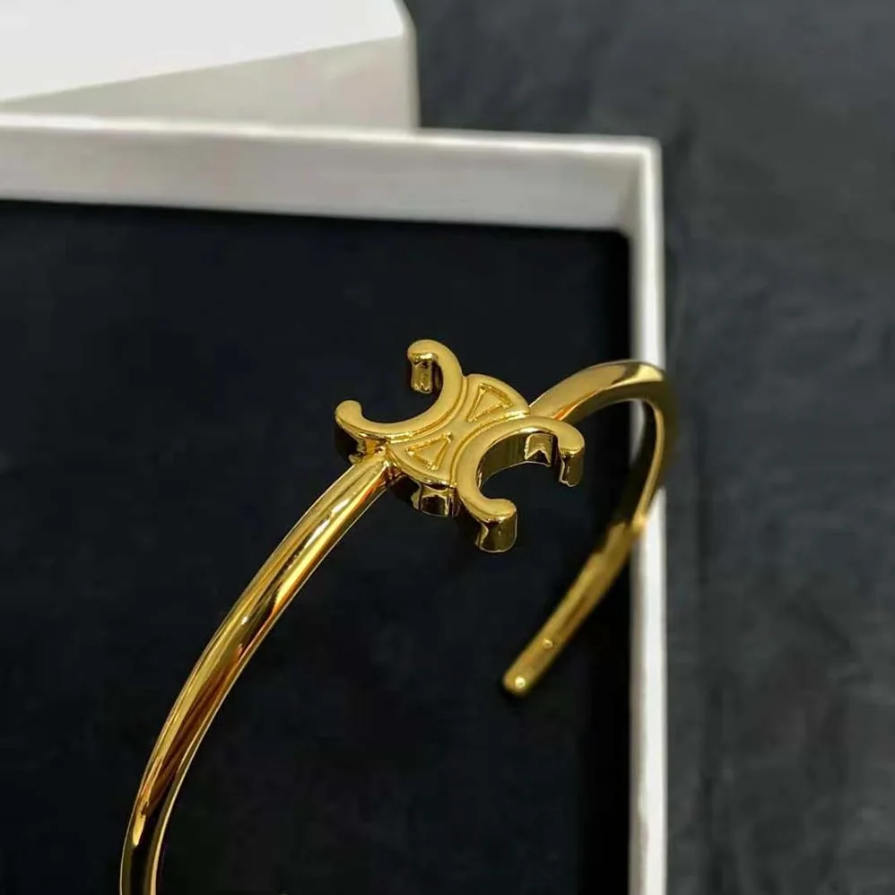 Celine Triomphe Asymmetric Cuff in Brass with Gold Finish for Women Celine Triomphe Asymmetric Cuff in Brass with Gold Finish for Women