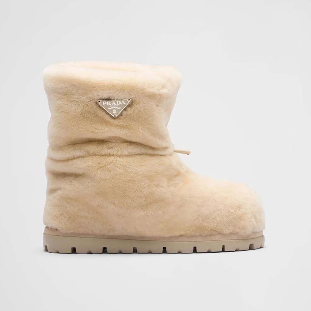 Prada Shearling Booties with Enameled Metal Triangle Logo for Women in Beige