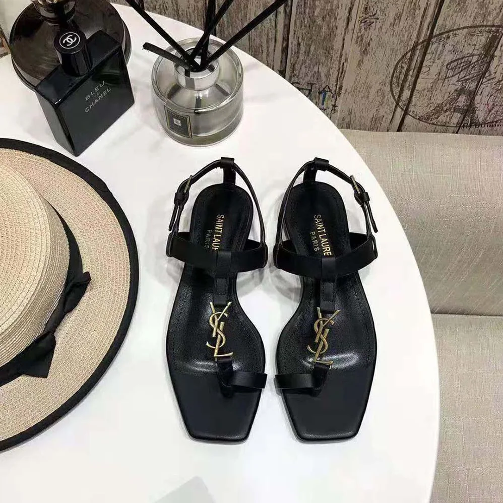 Saint Laurent YSL Cassandra Flat Sandals in Smooth Leather with Gold-tone Monogram for Women in Black