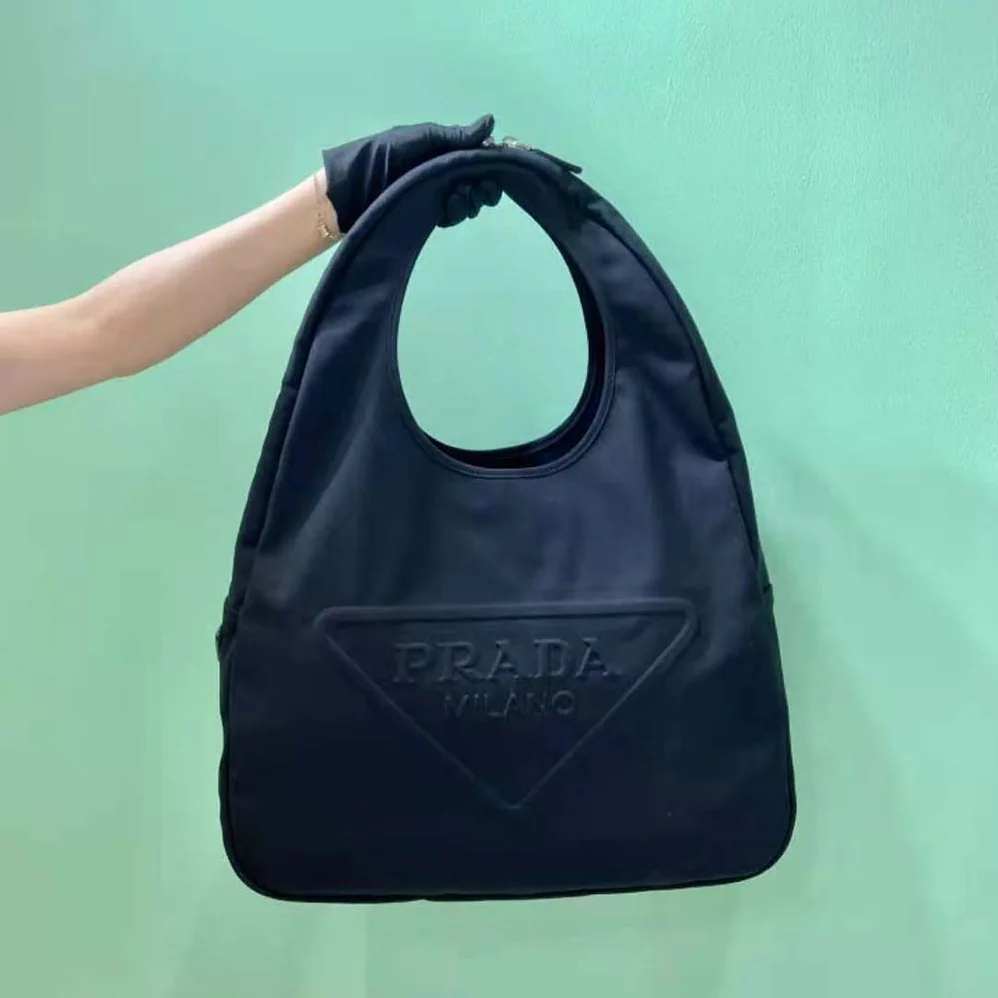 Prada Canvas Hobo Bag with Embossed Logo on the Front for Men in Black Prada Canvas Hobo Bag with Embossed Logo on the Front for Men in Black
