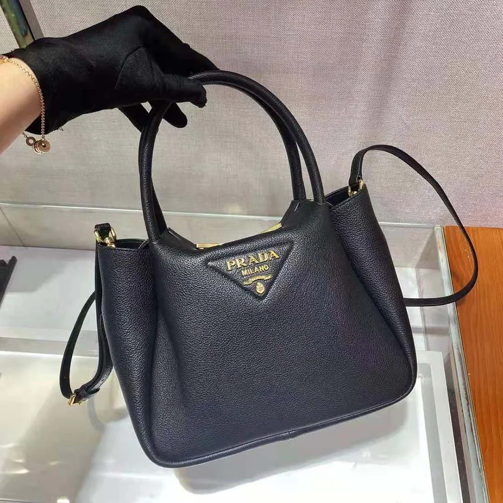 Prada Small leather Handbag with the Prada Metal Lettering Logo Illuminating Its Center for Women Prada Small leather Handbag with the Prada Metal Lettering Logo Illuminating Its Center for Women