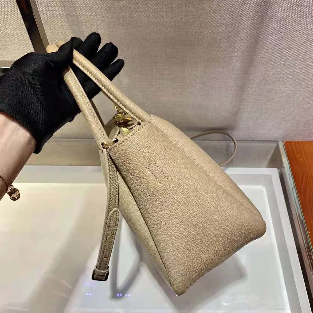 Prada Small leather Handbag with the Prada Metal Lettering Logo Illuminating Its Center for Women in Sandy