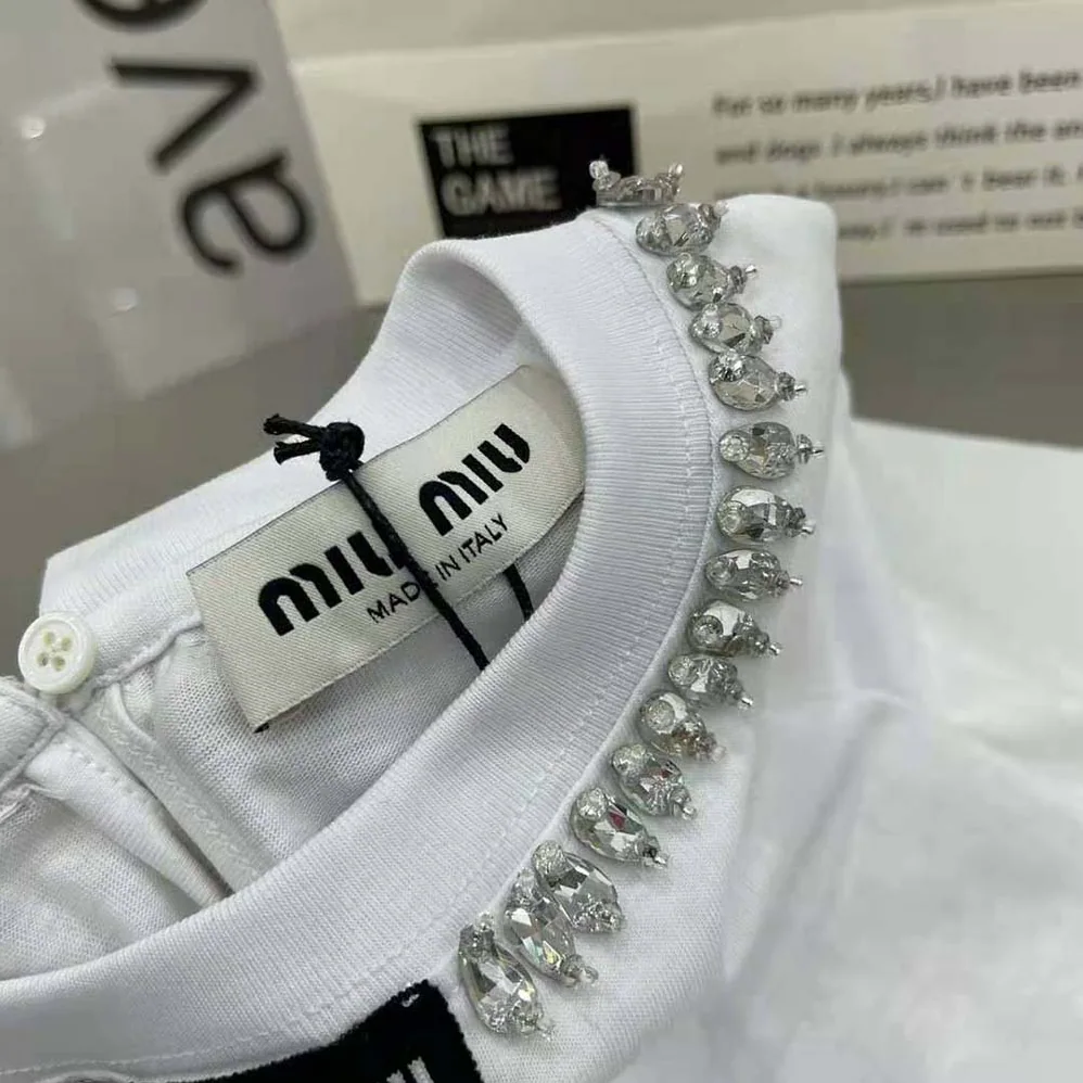 Miu Miu Embroidered Cotton T-shirt with Logo Patch for Women in White Miu Miu Embroidered Cotton T-shirt with Logo Patch for Women in White