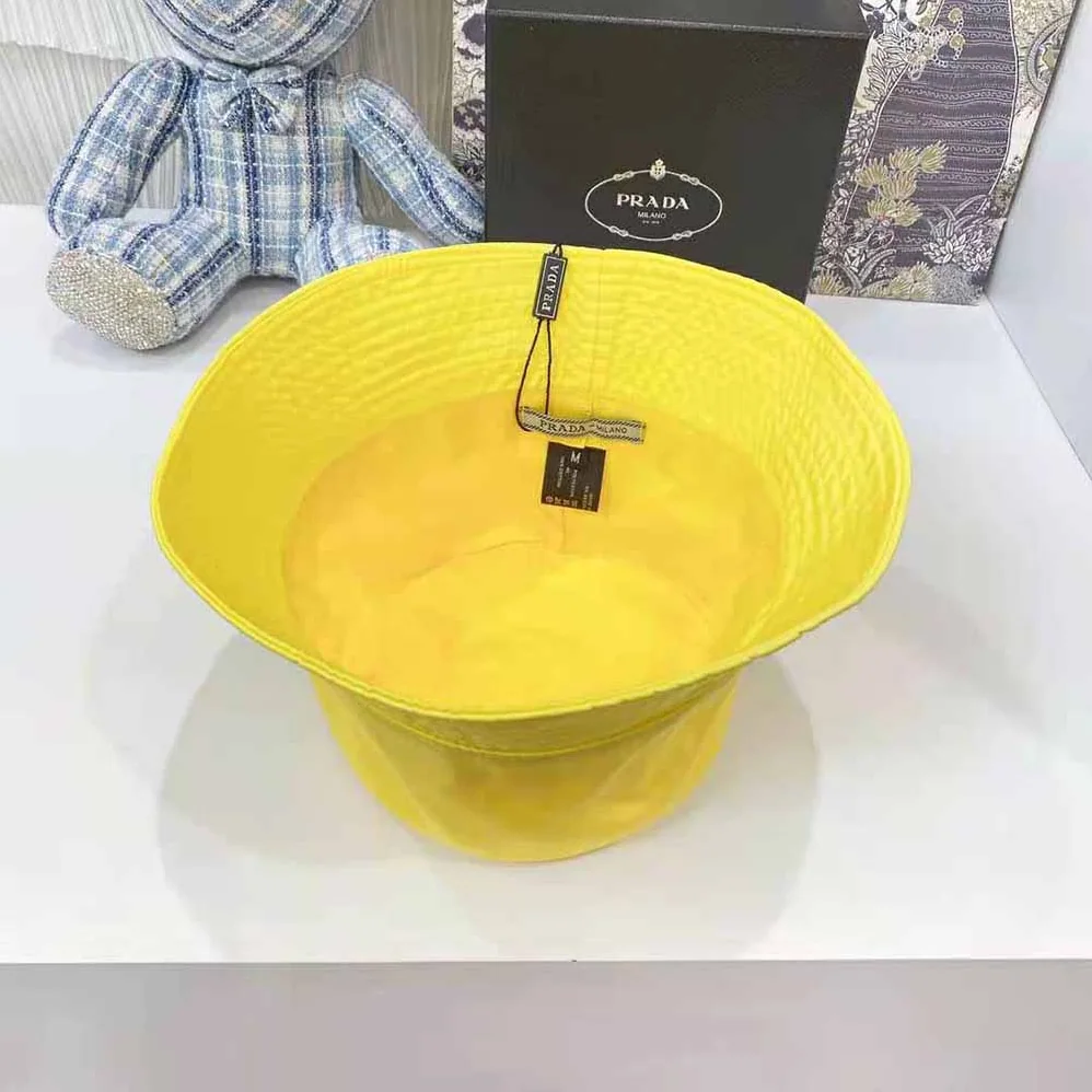 Prada Nylon Bucket Hat Decorated with the Triangle Logo for Women in Yellow