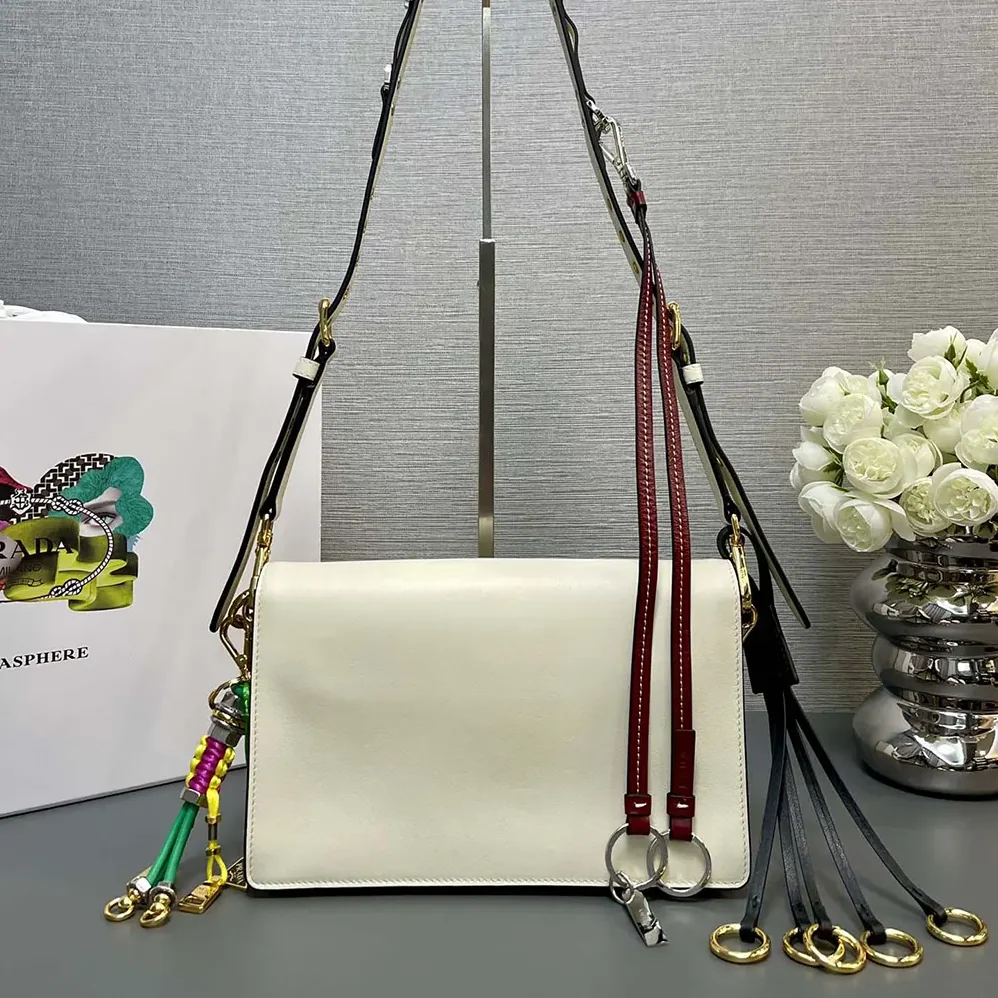 Prada Soft Sound Small Leather Shoulder Bag with Charms for Women in White Prada Soft Sound Small Leather Shoulder Bag with Charms for Women in White