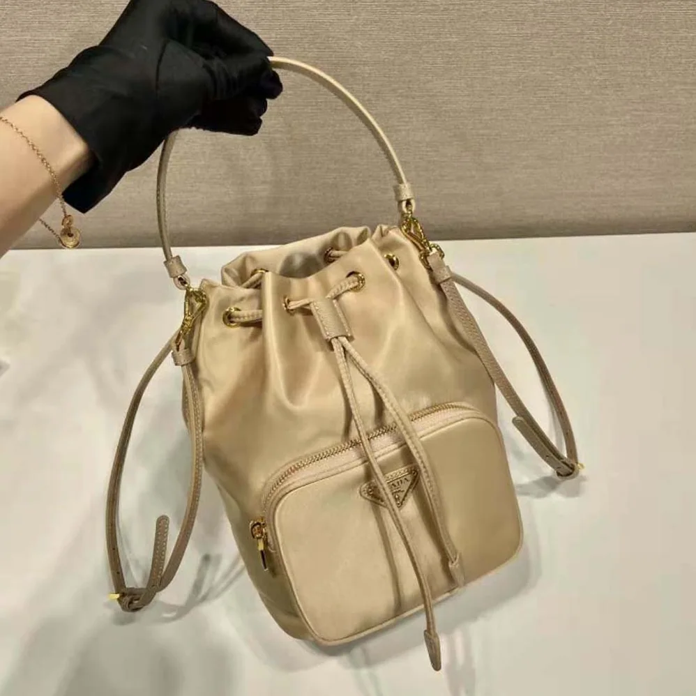 Prada Duet Re-Nylon Bucket Bag for Women in Beige