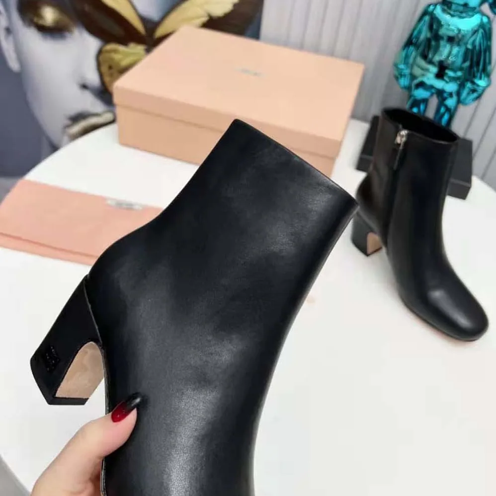 Miu Miu Leather Booties with Metal Lettering Logo for Women in Black