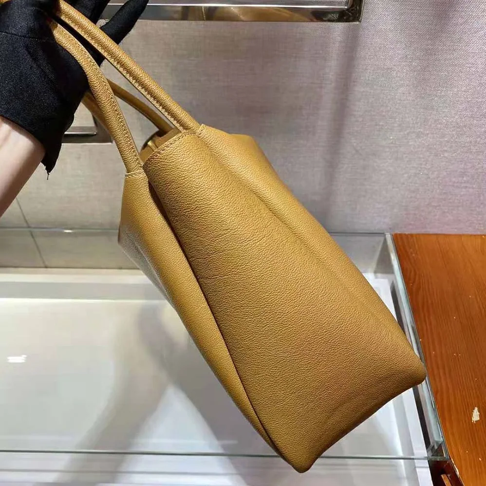 Prada Medium Leather handbag with the Prada Metal Lettering Logo Illuminating Its Center for Women
