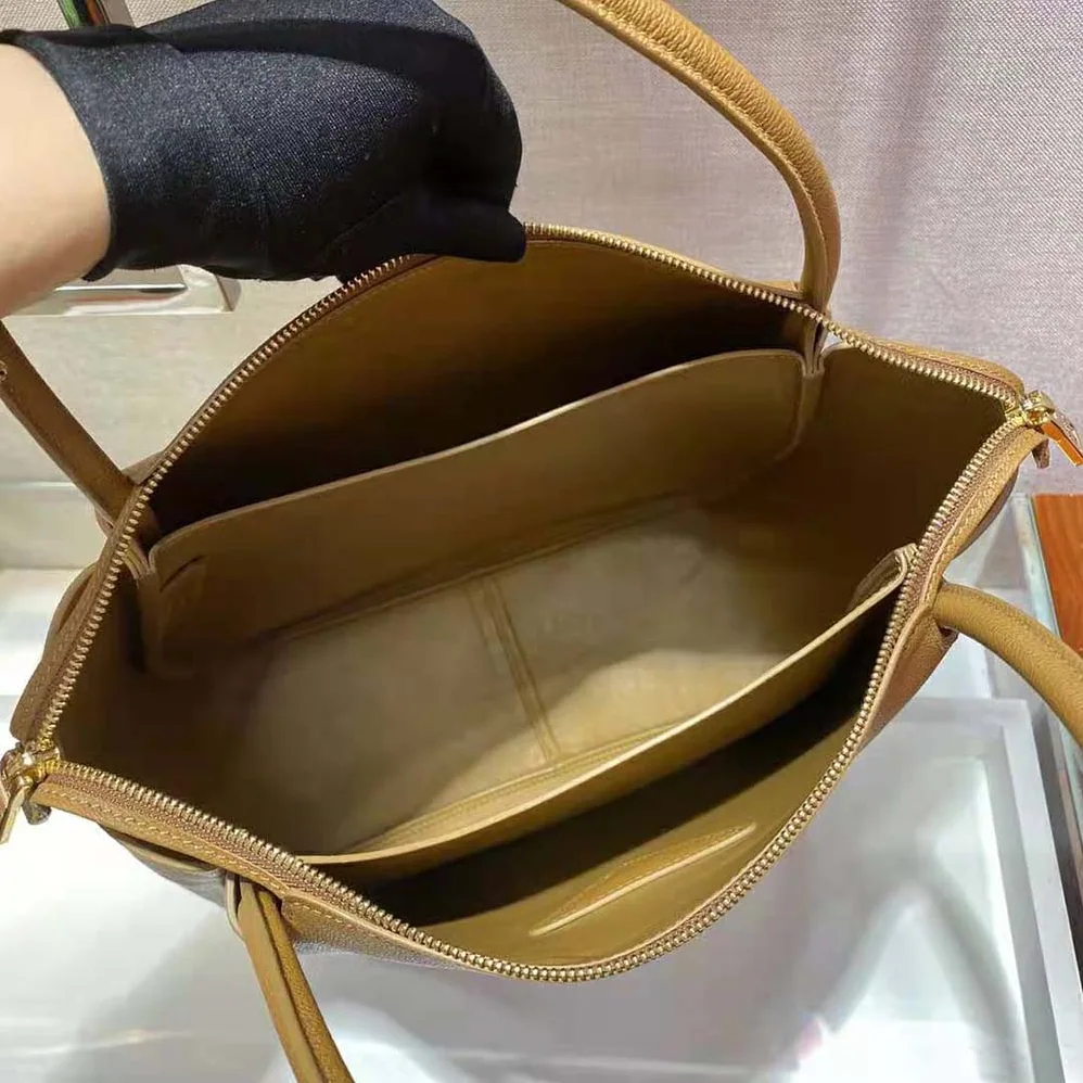 Prada Medium Leather handbag with the Prada Metal Lettering Logo Illuminating Its Center for Women