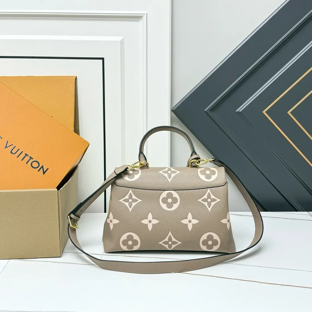 Louis Vuitton Madeleine MM Monogram Empreinte Dove Gray in Creme Beige