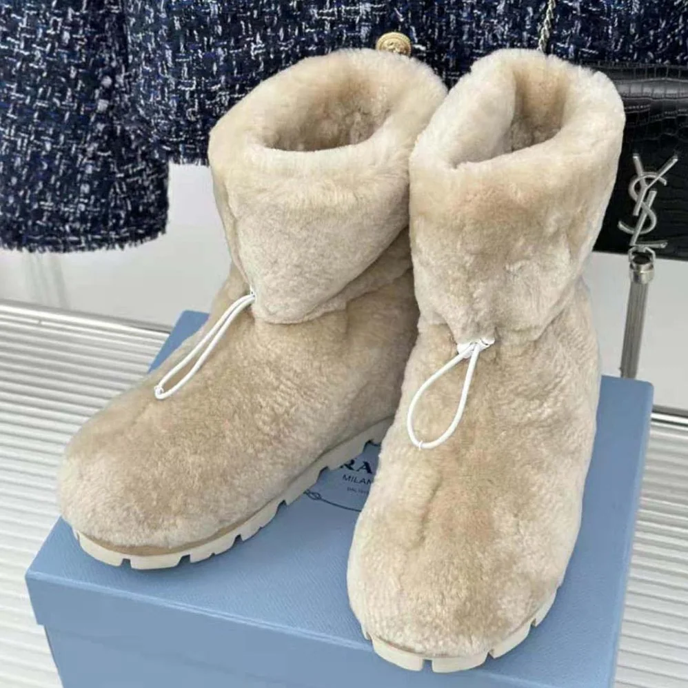 Prada Shearling Booties with Enameled Metal Triangle Logo for Women in Beige