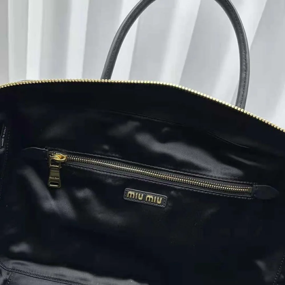 Miu Miu Leather Top-handle Bag with Embossed Lettering Logo for Women in Black Miu Miu Leather Top-handle Bag with Embossed Lettering Logo for Women in Black