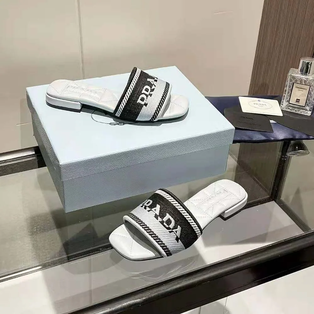 Prada Embroidered Fabric Slides With Embroidered Lettering Logo for Women in White Prada Embroidered Fabric Slides With Embroidered Lettering Logo for Women in White