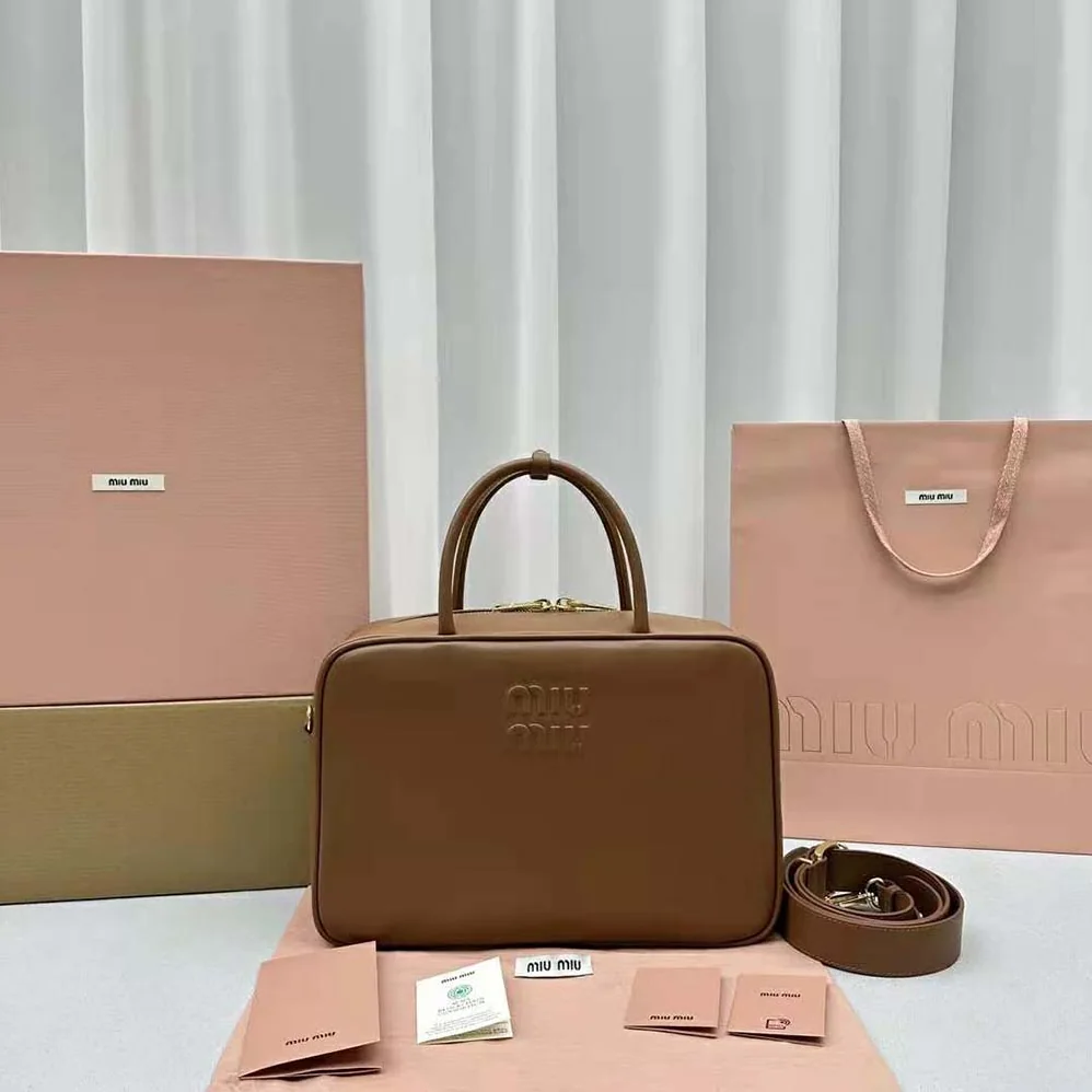 Miu Miu Leather Top-handle Bag with Embossed Lettering Logo for Women in Brown Miu Miu Leather Top-handle Bag with Embossed Lettering Logo for Women in Brown