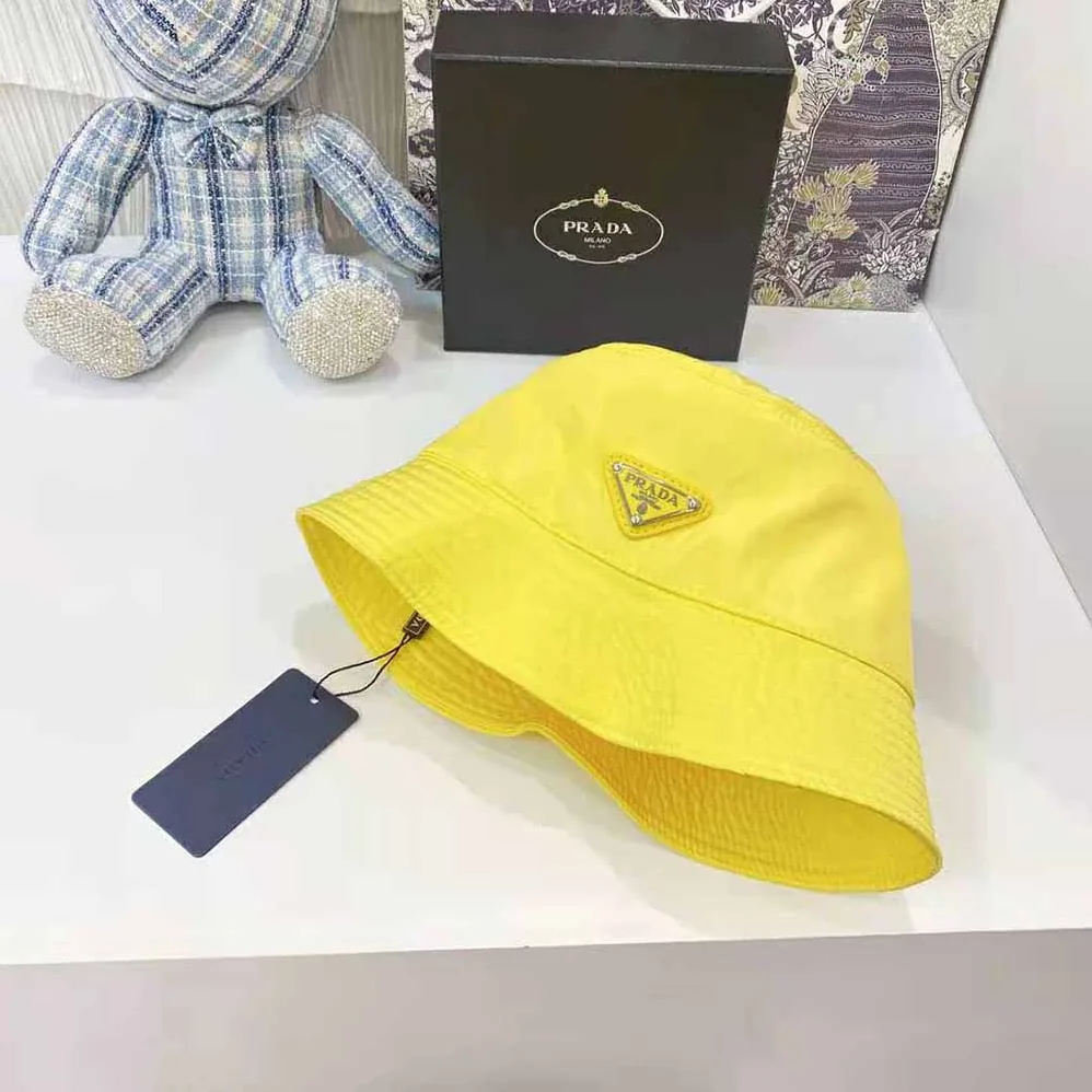 Prada Nylon Bucket Hat Decorated with the Triangle Logo for Women in Yellow