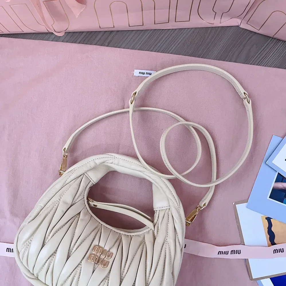 Miu Miu Wander Matelassé Nappa Leather Hobo Mini-Bag for Women in Light Yellow Miu Miu Wander Matelassé Nappa Leather Hobo Mini-Bag for Women in Light Yellow