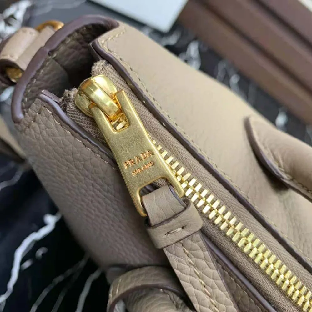 Prada Leather Handbag with Metal lettering Logo on the Front for Women in Beige Prada Leather Handbag with Metal lettering Logo on the Front for Women in Beige