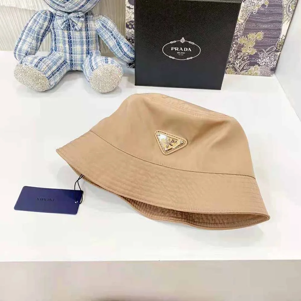 Prada Nylon Bucket Hat Decorated with the Triangle Logo for Women in Sandy Prada Nylon Bucket Hat Decorated with the Triangle Logo for Women in Sandy