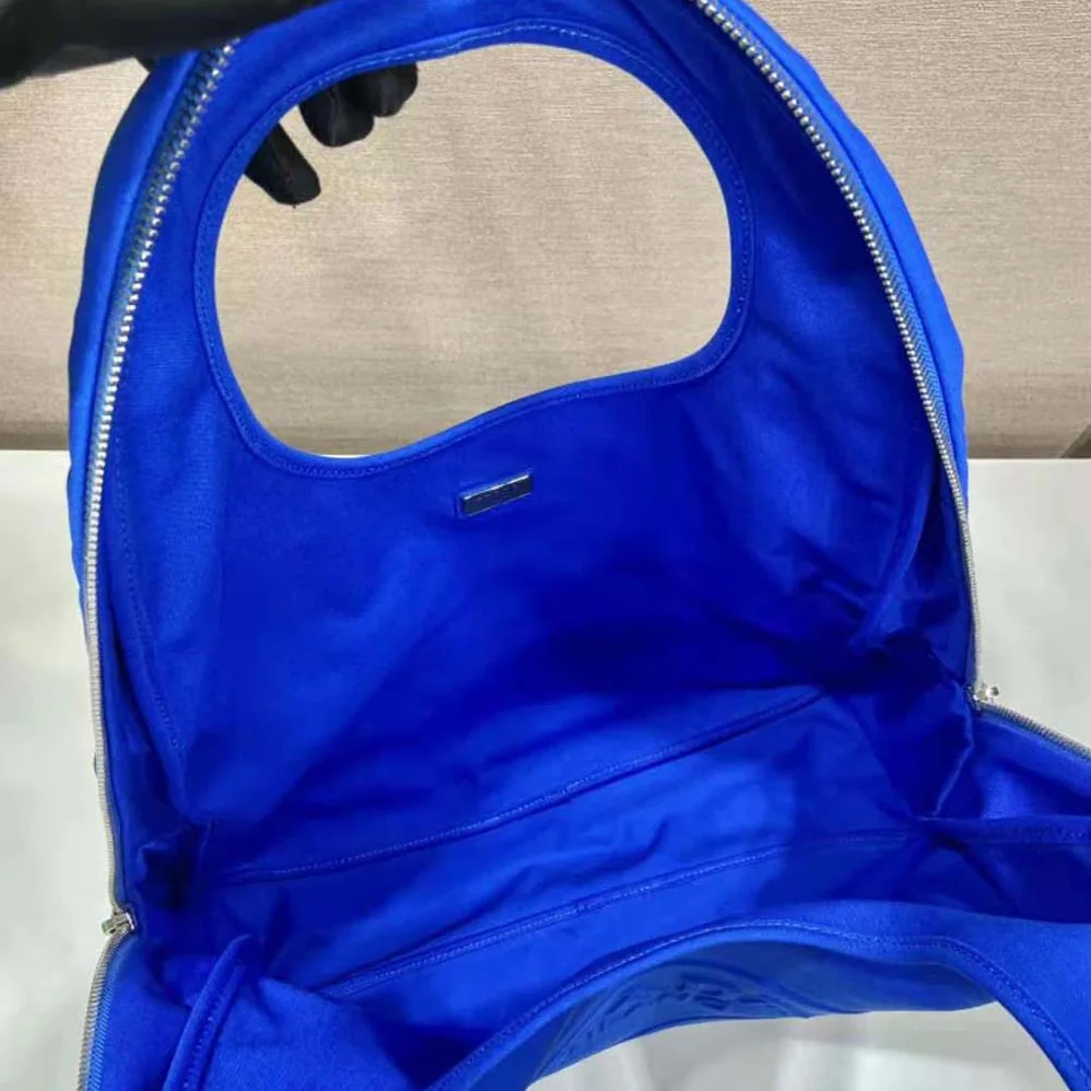 Prada Canvas Hobo Bag with Embossed Logo on the Front for Men in Blue Prada Canvas Hobo Bag with Embossed Logo on the Front for Men in Blue