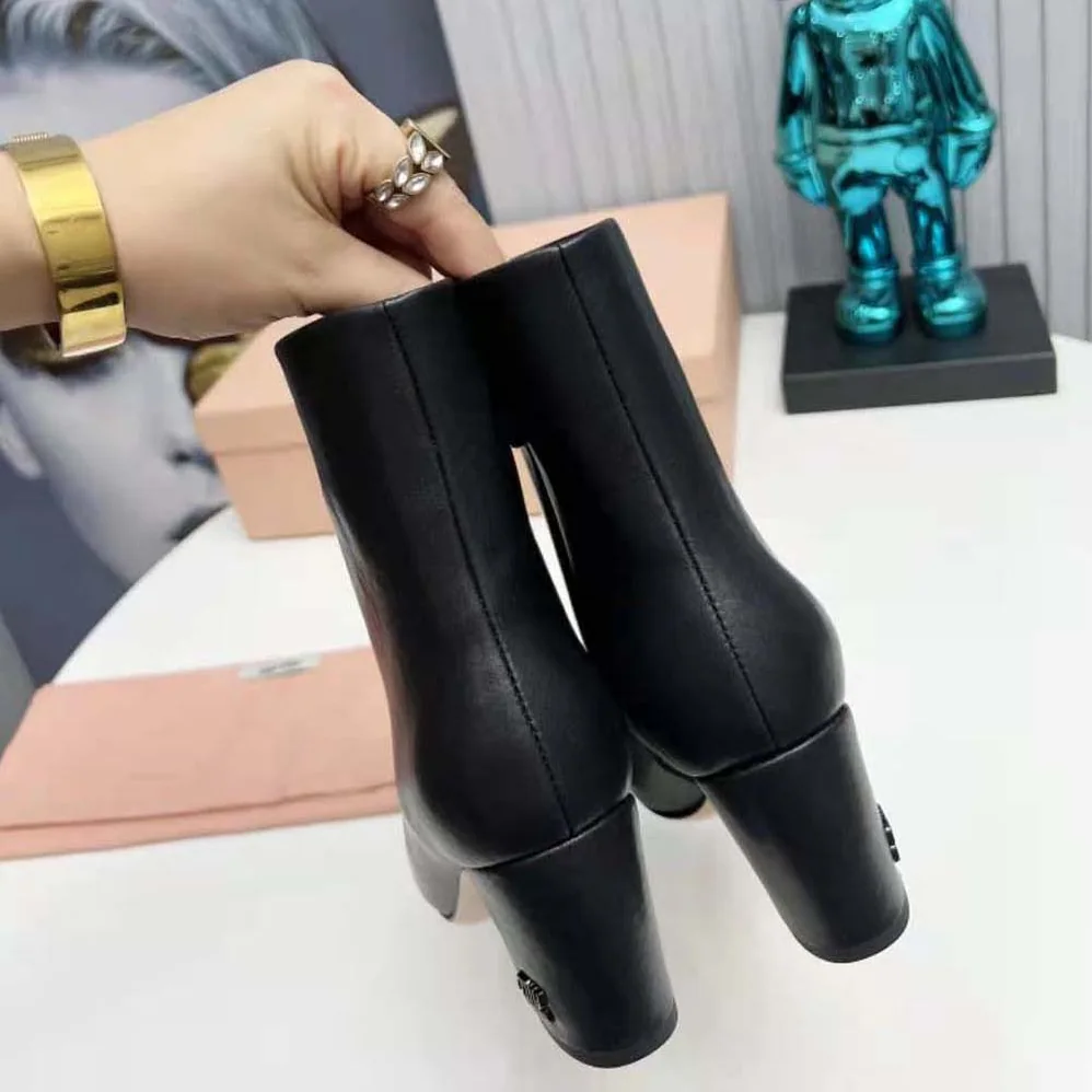 Miu Miu Leather Booties with Metal Lettering Logo for Women in Black