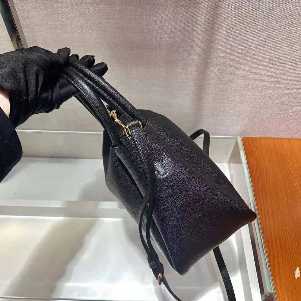 Prada Small leather Handbag with the Prada Metal Lettering Logo Illuminating Its Center for Women Prada Small leather Handbag with the Prada Metal Lettering Logo Illuminating Its Center for Women