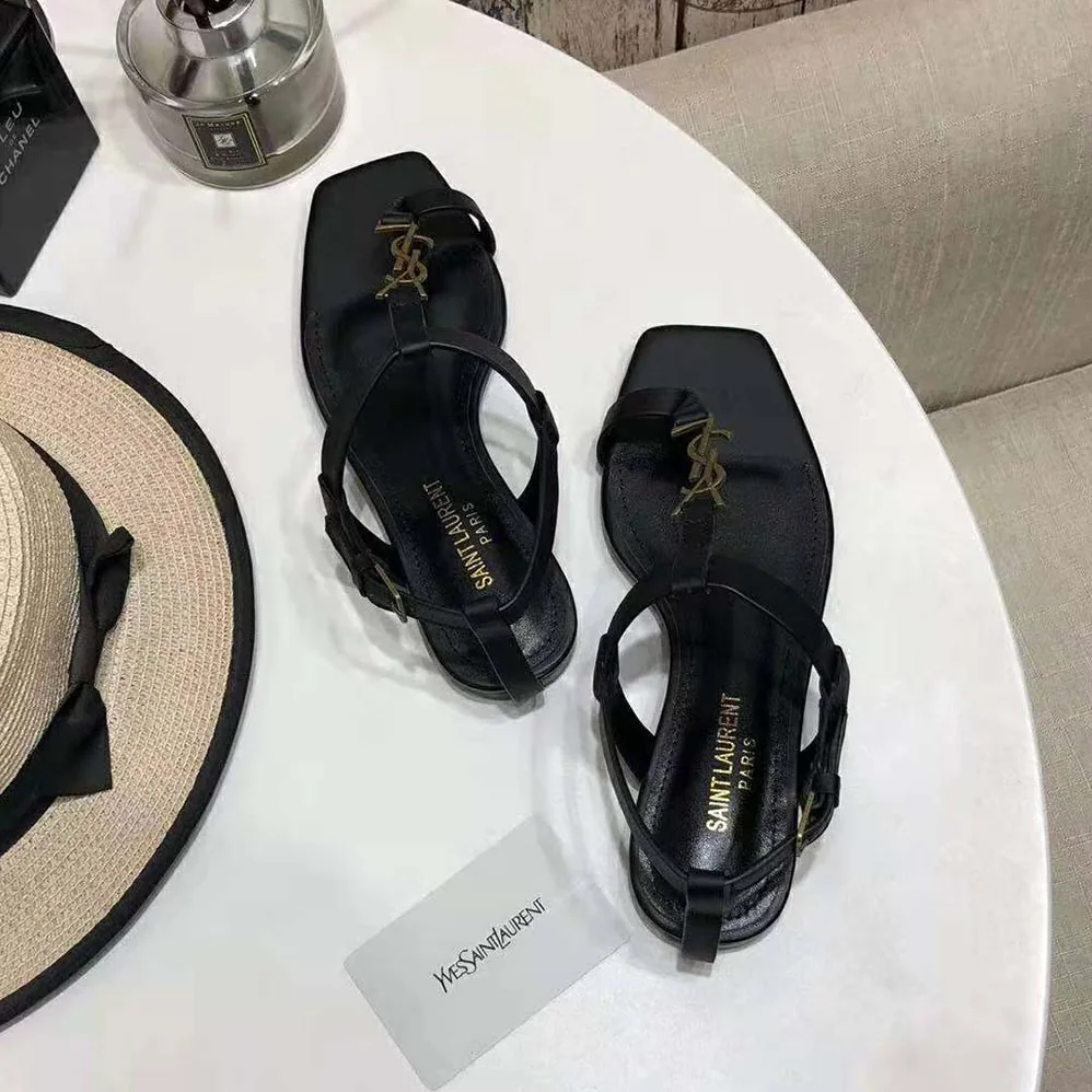 Saint Laurent YSL Cassandra Flat Sandals in Smooth Leather with Gold-tone Monogram for Women in Black
