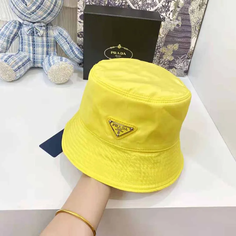 Prada Nylon Bucket Hat Decorated with the Triangle Logo for Women in Yellow