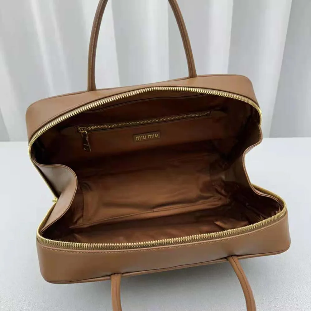 Miu Miu Leather Top-handle Bag with Embossed Lettering Logo for Women in Brown Miu Miu Leather Top-handle Bag with Embossed Lettering Logo for Women in Brown
