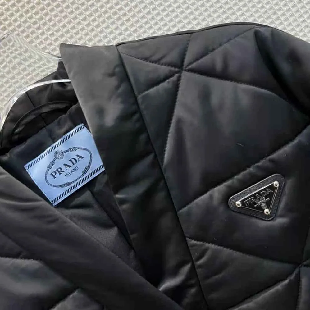 Prada Emblematic Triangle Quilted Re-Nylon Jacket for Women in Black Prada Emblematic Triangle Quilted Re-Nylon Jacket for Women in Black