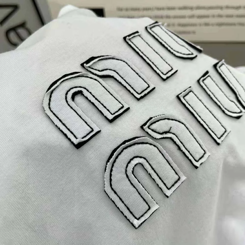 Miu Miu Embroidered Cotton T-shirt with Embroidered Logo for Women in White Miu Miu Embroidered Cotton T-shirt with Embroidered Logo for Women in White