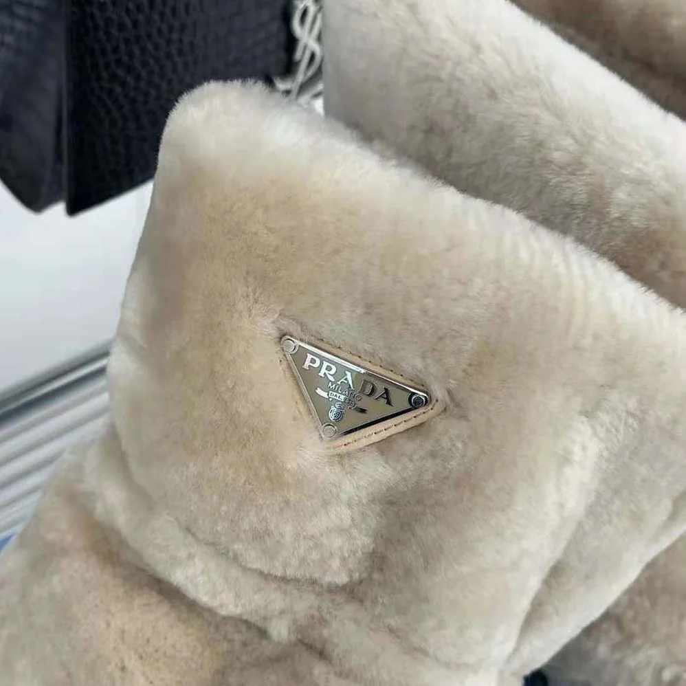 Prada Shearling Booties with Enameled Metal Triangle Logo for Women in Beige