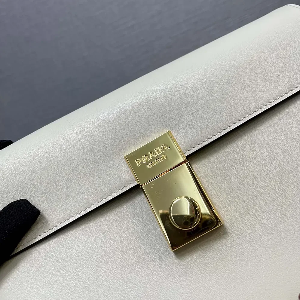 Prada Soft Sound Small Leather Shoulder Bag with Charms for Women in White Prada Soft Sound Small Leather Shoulder Bag with Charms for Women in White
