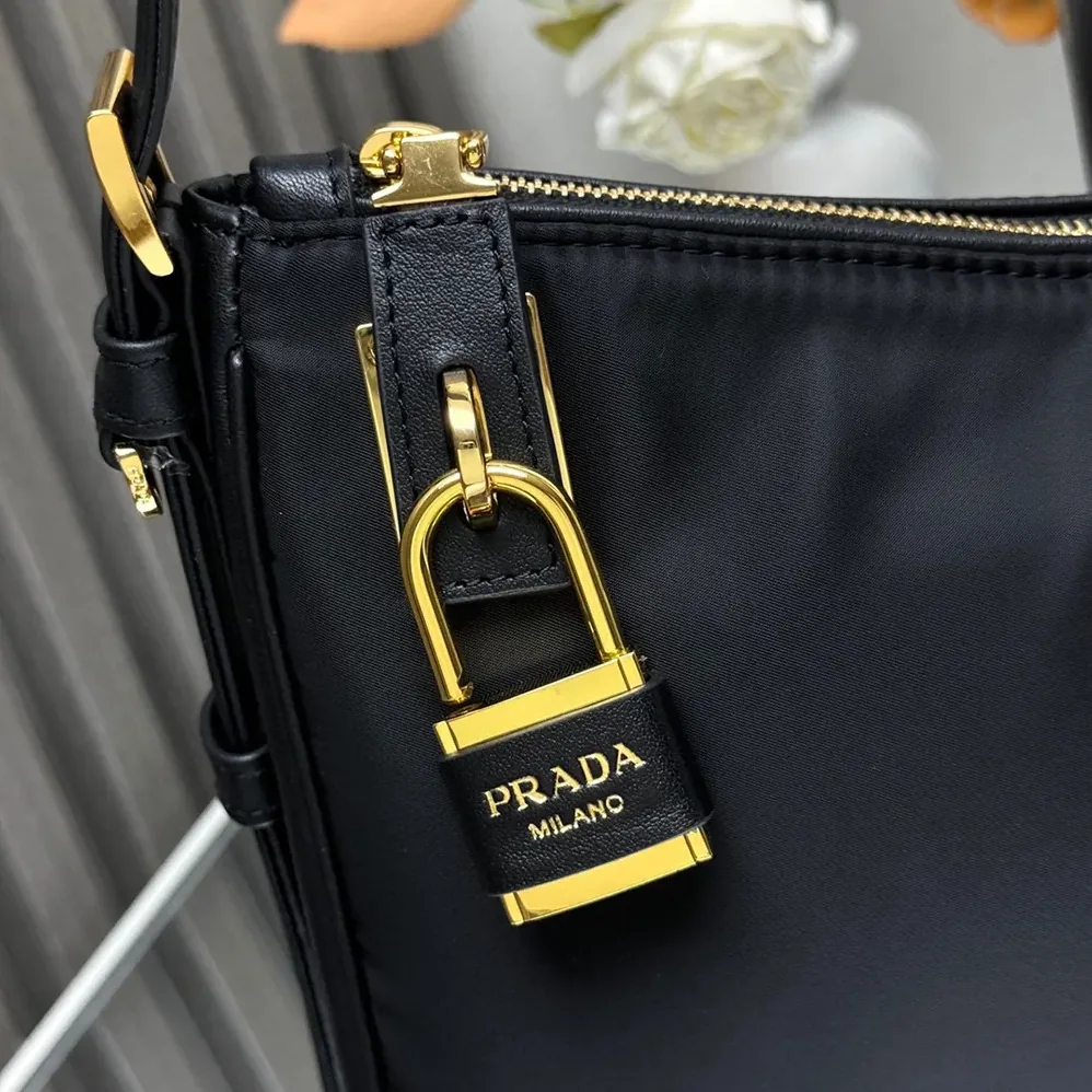 Prada Aimée large Re-Nylon and Leather Shoulder Bag with Padlock for Women Prada Aimée large Re-Nylon and Leather Shoulder Bag with Padlock for Women