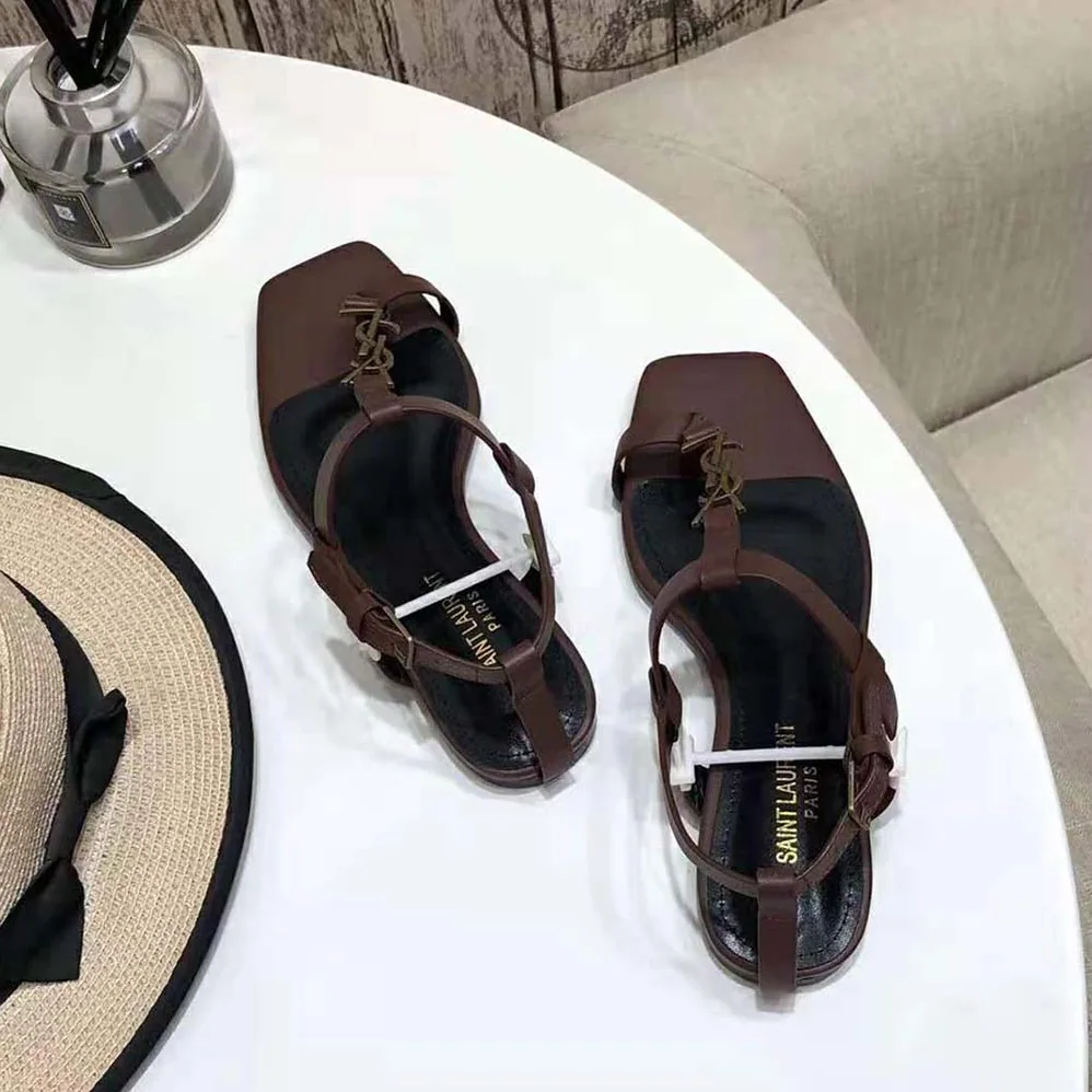 Saint Laurent YSL Cassandra Flat Sandals in Smooth Leather with Gold-Tone Monogram for Women in Brown