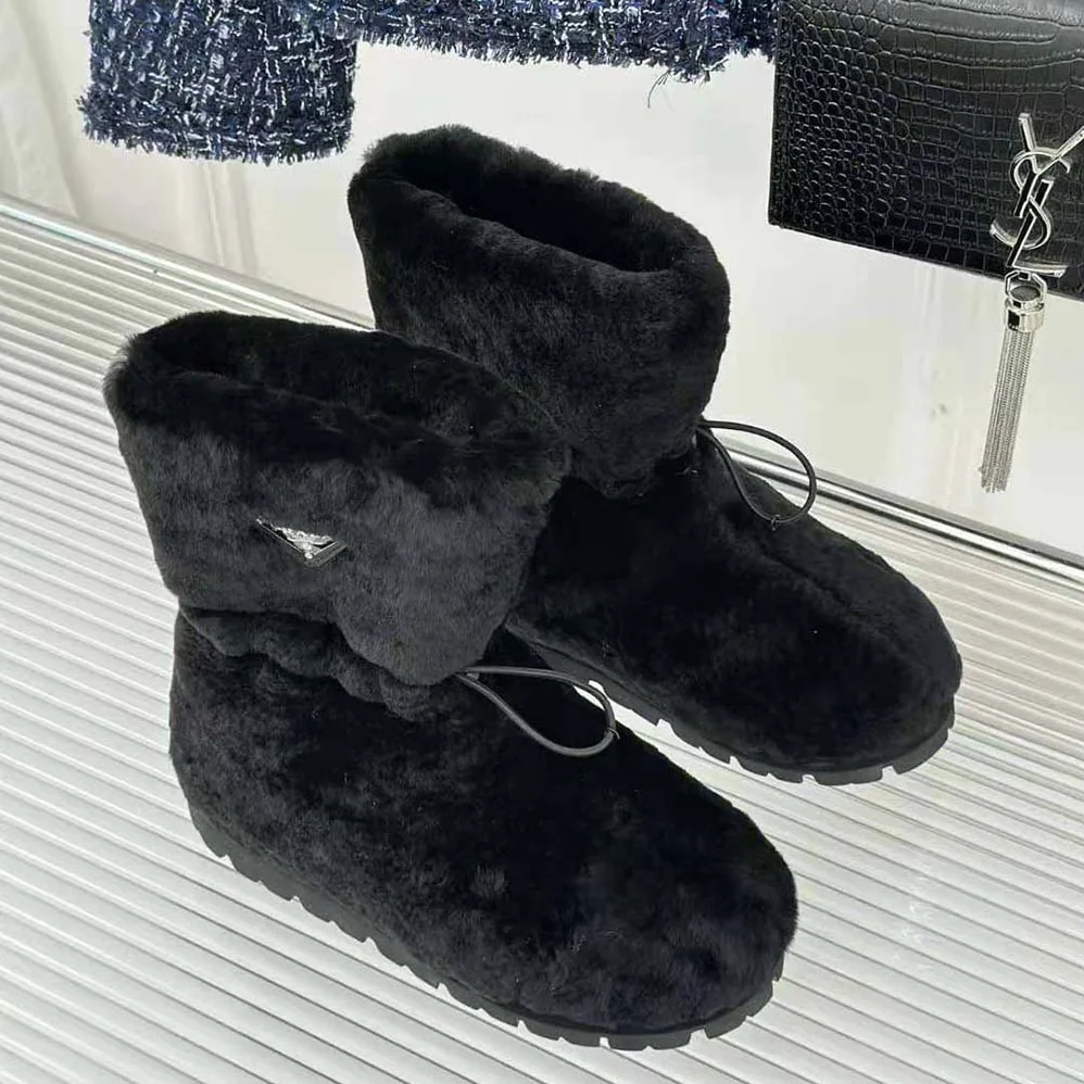 Prada Shearling Booties with Enameled Metal Triangle Logo for Women in Black