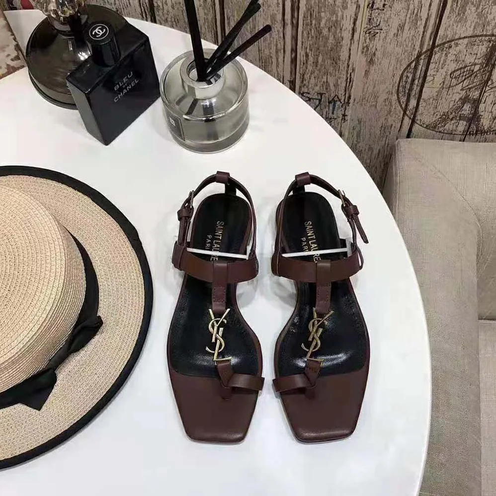 Saint Laurent YSL Cassandra Flat Sandals in Smooth Leather with Gold-Tone Monogram for Women in Brown
