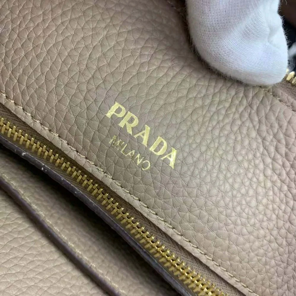 Prada Leather Handbag with Metal lettering Logo on the Front for Women in Beige Prada Leather Handbag with Metal lettering Logo on the Front for Women in Beige